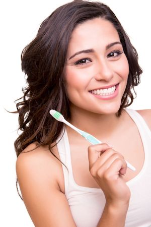 oral health pic of girl holding toothbrush out