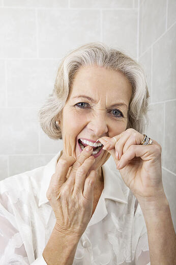 Senior woman flossing healthy teeth for life